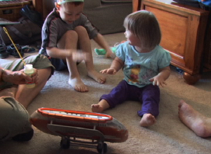 Watch and listen to other children at play: KW plays bubbles